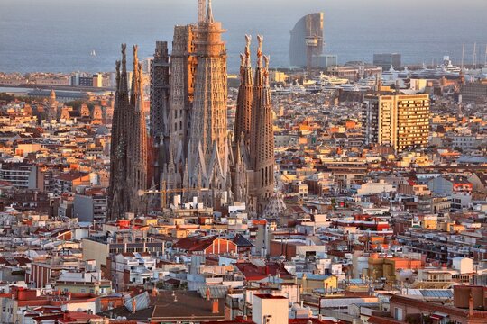 Barcelona cityscape with Sagrada Familia and Mediterranean Sea in background. Sunset city view of Barcelona, Spain.