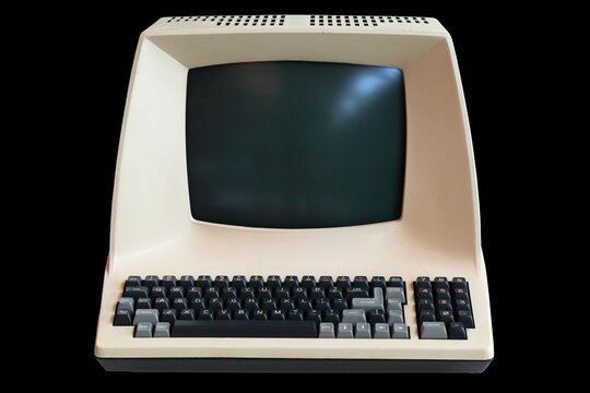 Old personal computer isolated on black background. Vintage PC.
