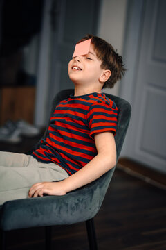 Little boy laughing playing funny guessing game