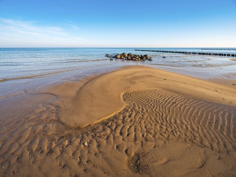 Pristine beach on the Baltic Sea with groynes, sandbank, boulders and sand ripples, Baltic resort K&uuml;hlungsborn, Mecklenburg-Western Pomerania, Germany