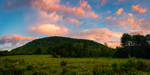 Fototapeta premium Sunrise Panoramic cloudscape over Mt Ascutney State Park meadow and Little Ascutney State Wildlife Management Area in Wethersfield, Vermont, United States