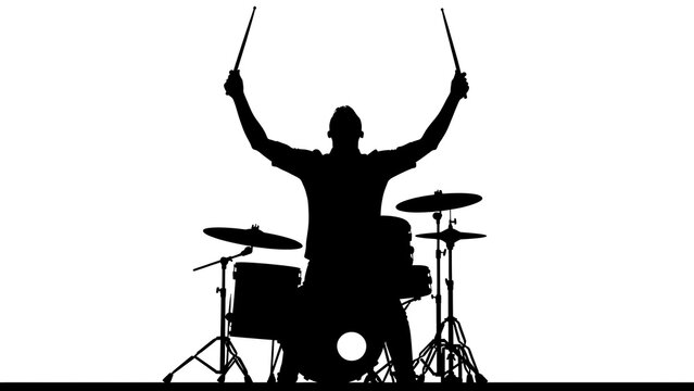 Silhouette of person celebrating on mountain peak.