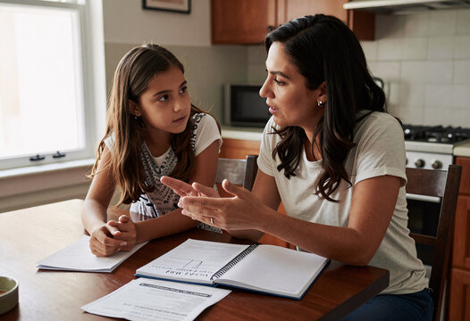 Latina Mother Teaching Daughter About Money Management