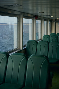 Empty chairs near windows on a public ferry in Washington state
