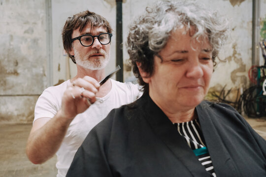 Outdoor Haircut Against Weathered Wall