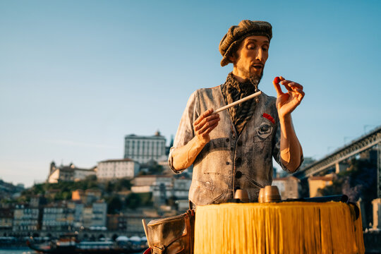 Street Performer Entertains Crowd by the River in Porto