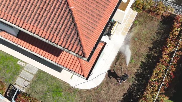 Drone shot of professional fumigation treatment in residential neighborhood green spaces