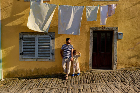 Father and child in old town street