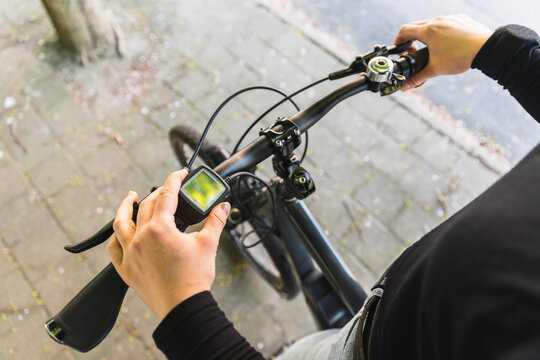 POV of cyclist hands on e-bike handlebars with digital display
