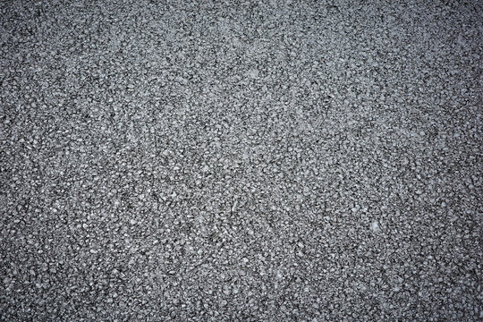Rough grey aggregate road surface texture