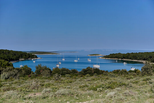 Sailboats anchored in a blue bay