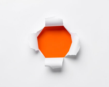 A rip in white paper reveals a vibrant, hexagonal orange opening