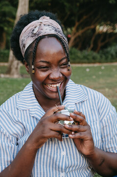 Girl smiling and holding drink