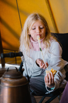 A girl is eating a slice of pizza