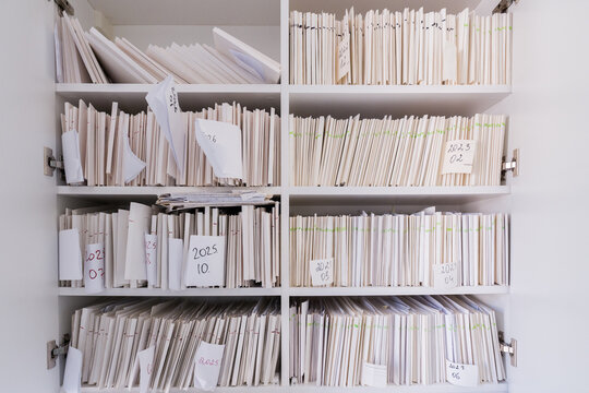 Organized Files on Shelves in a Tidy Office Space