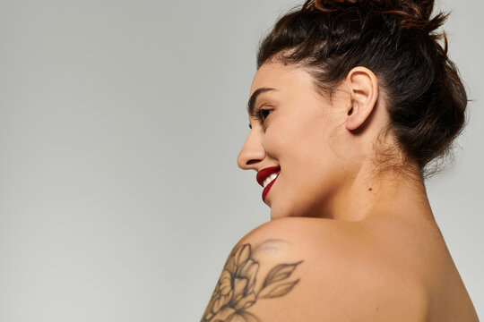 A young, beautiful woman showcases her confidence and charm while posing naturally.