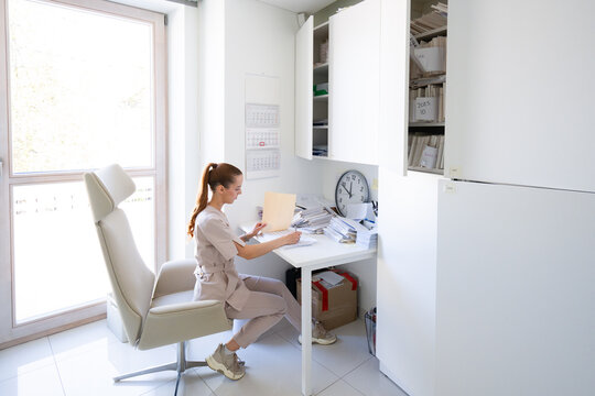 Woman Working at Desk in Office During the Day