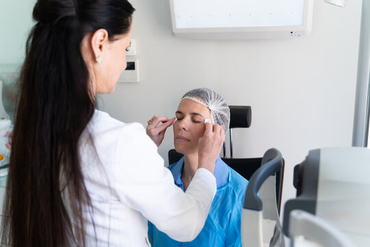Doctor Prepare Patient for Eye Surgery in Clinic