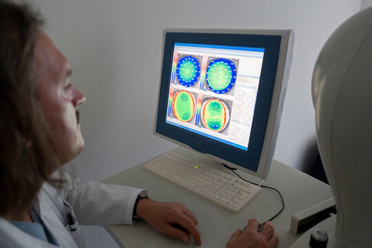 Ophthalmologist Examines Medical Data on Computer Screen 
