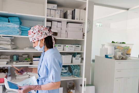 Health Worker Organizes Medical Supplies in Clinic
