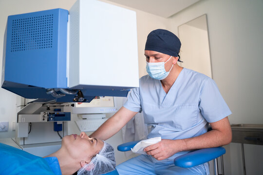 Doctor Performing Eye Surgery on Patient in Clinic 
