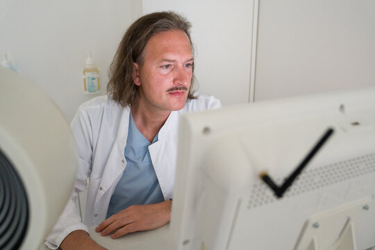 Doctor Working on a Computer in Clinic Room