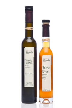 IRVINE, CALIFORNIA - 24 JUN 2026: Two bottles of Temecula Olive Oil Company products, Fresh Basil Olive Oil and Fresh Apple Balsamic Vinegar.