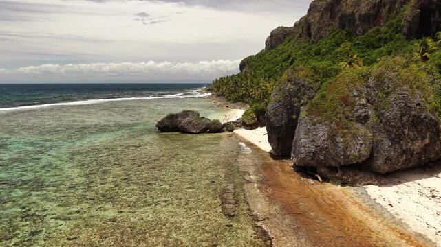 Wide aerial landscape of Fronton Beach under bright tropical daylight.