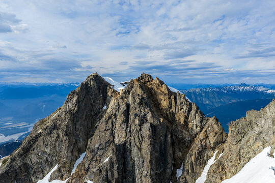 Rugged Alpine Mountain Peaks With Snow-Capped Summit and Expansive Sky in British Columbia, Canada