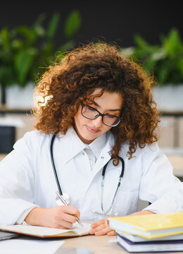 Medical student writing notes during a study session