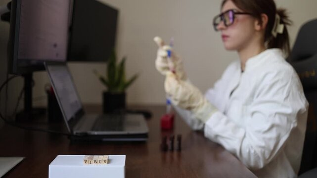 Medical researcher studies blood test indicators while comparing laboratory results with digital records Focused analysis helps evaluate patient health conditions