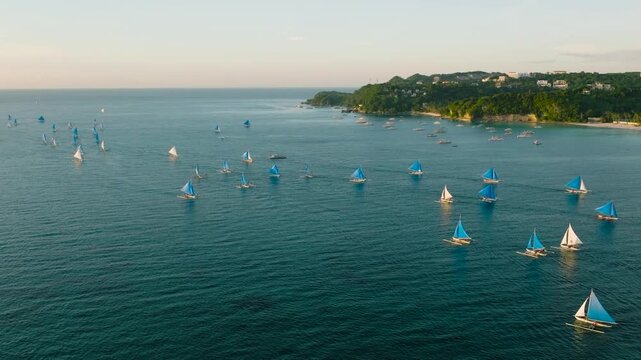 Drone view of boats over the sea. Para sailing in Boracay. Sunset view. Philippines.