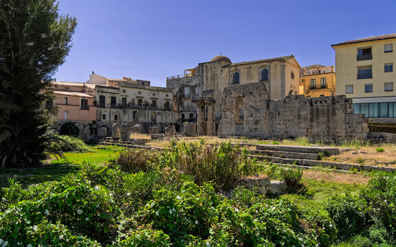 Sunny northern view of the monumental Temple of Apollo archaeological remains in  Pancali Square, Siracusa, Italy. Picturesque Mediterranean heritage site and tourist destination.