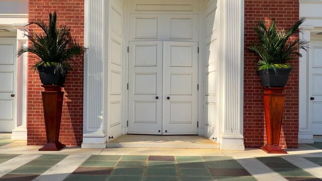 Vases of palm tree branches on the sides of church entry doors on Palm Sunday