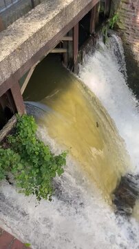 river water dammed up at an old grain mill