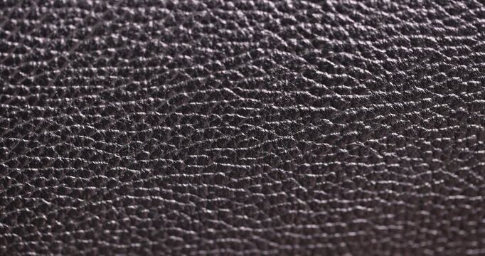details of a natural black leather   after prolonged use, details and pieces of natural leather used for the production of items, color