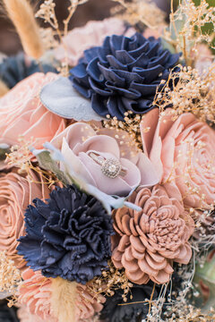a wedding diamond ring in a Wooden Bridal Flower Bouquet Arrangement closeup