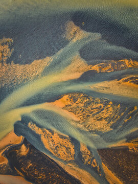 Aerial view of the intricate patterns of the glacial river delta with sediment-rich channels and sandbars near Selfoss, Sveitarfelagid Arborg, Iceland.