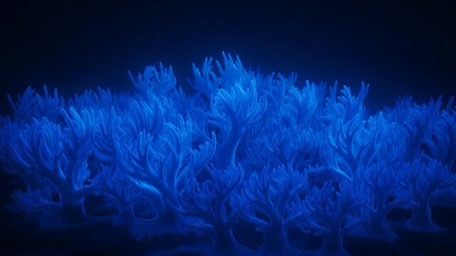 Fluorescent coral reef glowing under ultraviolet light in dark aquarium.