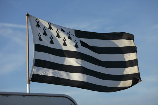 Waving flag of Brittany against a clear blue sky