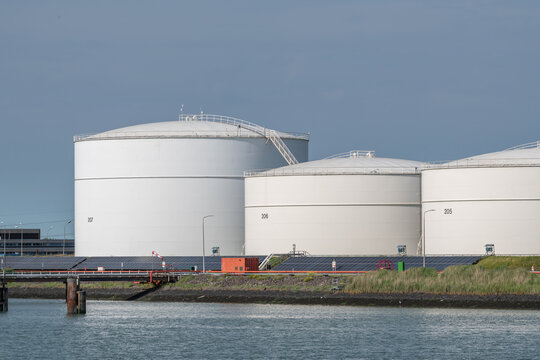 Vlissingen, Netherlands. Large petroleum and biofuel storage tanks with solar panels at coastal industrial energy site