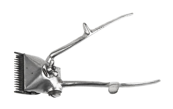 An old metal manual hair clipper isolated on a white background.