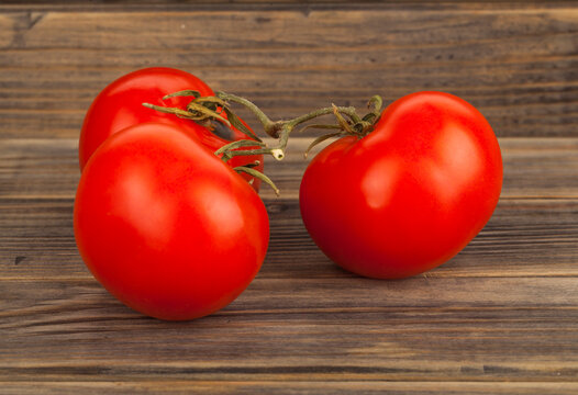 Tomatoes on a wooden background.