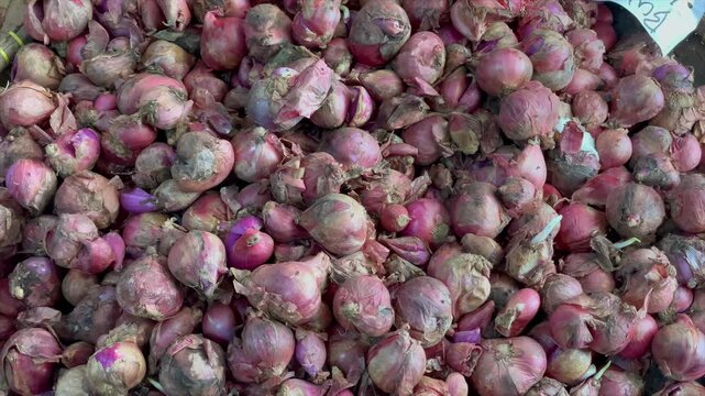Pile of fresh shallots at a traditional market