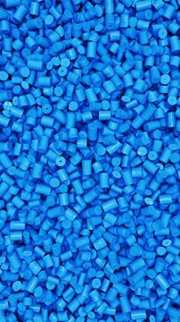 Pan across blue polypropylene plastic granules and industrial masterbatch resin pellets, 3D render dynamic Vertical video.