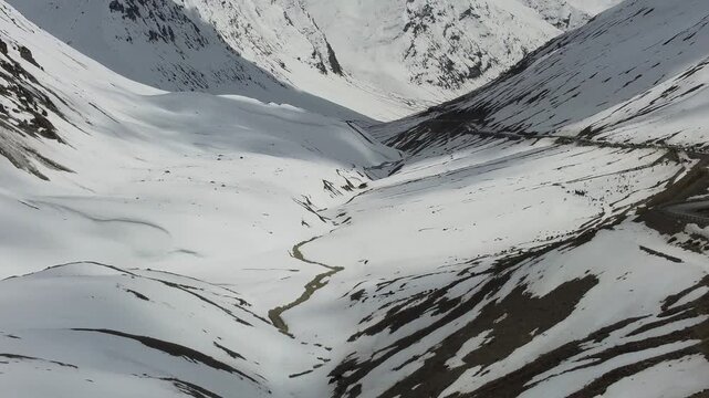 Scenic Winter Landscape at high mountain Pass with Snow Covered Peaks