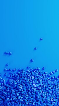 Close-up top view of rotating blue polypropylene plastic granules and masterbatch resin pellet pile, 3D render seamless Vertical video.