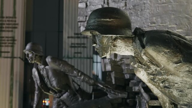 Bronze Soldiers of Warsaw Uprising Monument Illuminated at Night