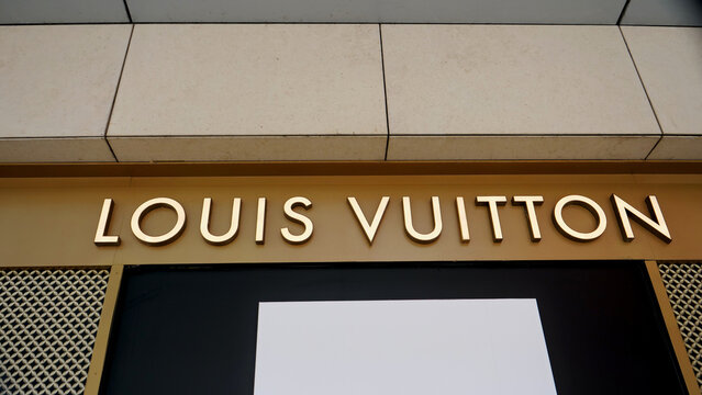 Manchester, England, UK - 18 June 2026: Louis Vuitton storefront sign, luxury boutique flagship store gold text logo font lettering on elegant shop facade exterior