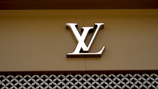 Manchester, England, UK - 18 June 2026: Louis Vuitton LV monogram logo sign close up, luxury corporate emblem metallic symbol on elegant boutique store facade